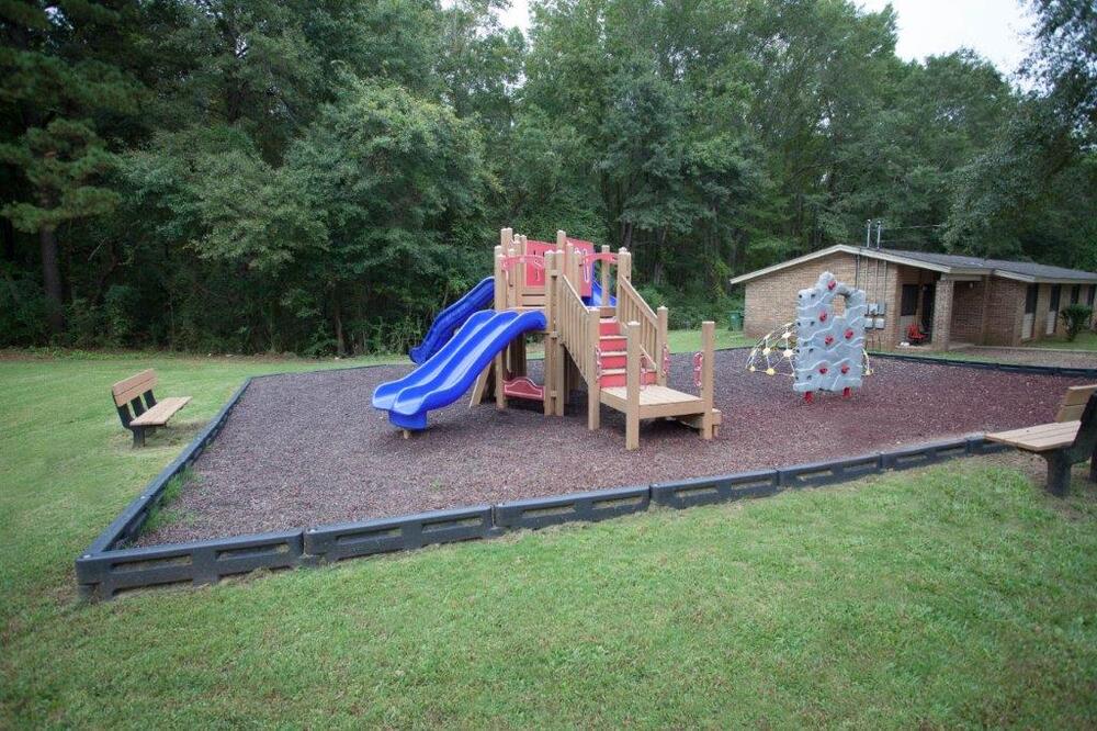 Playground with slides, climbing wall, and benches