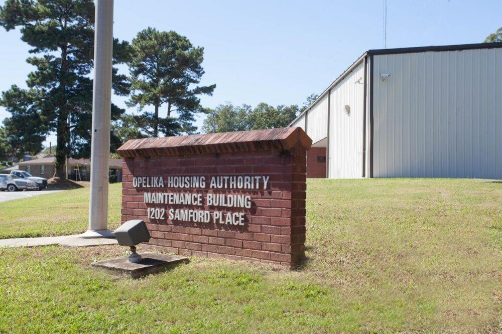 Brick Sign in front of a building that reads 