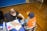 A nurse is administering the COVID Vaccine 