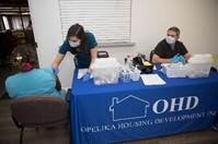 A volunteer administers the COVID Vaccine to a resident